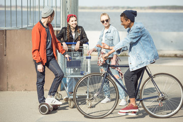 stylish teenagers spending time in skateboard park, hipster style concept