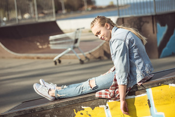 stylish teenage girl at skateboard park, hipster style concept