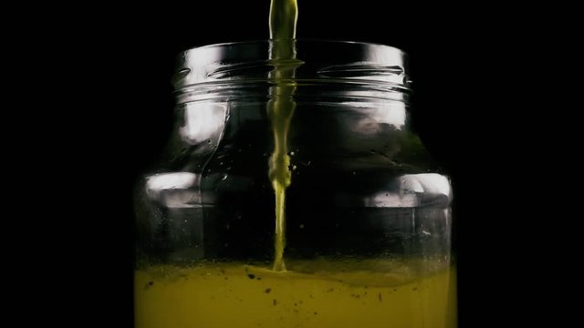 Slow motion, Pure clear broth is poured into jar for canning