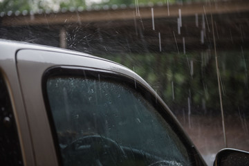 Car wet . heavy rain  outdoor in rainy season .