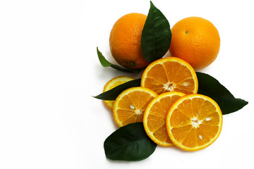 Fresh oranges with green leaves isolated on white.