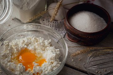 Fresh dairy products. Milk, cottage cheese, sour cream, fresh eggs and wheat on rustic wooden background.