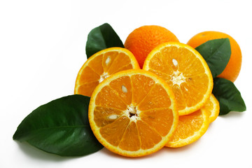 Fresh oranges with green leaves isolated on white.