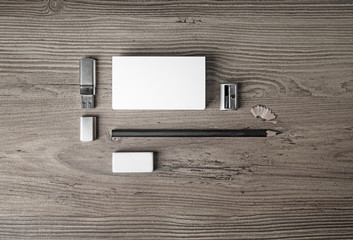 Blank paperwork template for designers. Responsive design mockup. Business cards, pencil, eraser, flash drive and sharpener on wooden table background. Top view.
