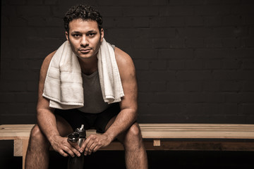 handsome man resting at gym locker room