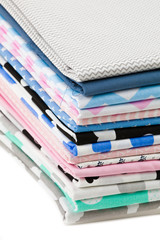 Stack of cotton fabric material isolated on white