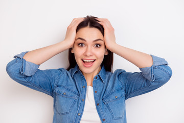Portrait of very excited happy girl holding her head in amazement on white background