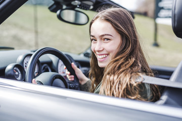 young brunette woman in new car