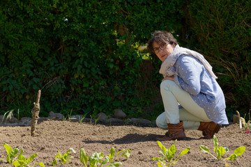 mature woman in her vegetable garden