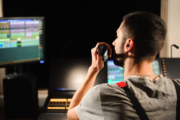A lighting engineer works with lights technicians control on the concert show. Professional light...