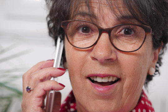 Portrait of mature brunette woman talking on phone