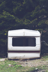 damaged car trailer in the woods