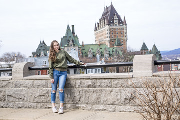 Obraz premium Quebec City scape with Chateau Frontenac and young teen enjoying the view.