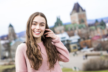 Quebec City scape with Chateau Frontenac and young teen enjoying the view.