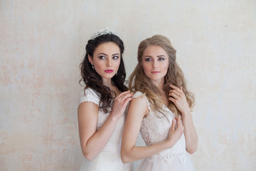 two girls in white dresses brunette and blonde