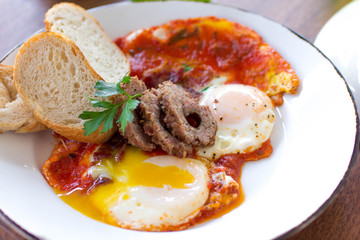 Eggs over medium with sausage and fresh baked bread