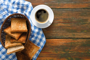 Breakfast background, toast and coffee on rustic wood, top view