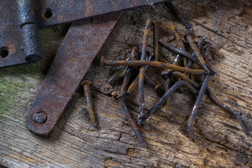 Group of rusty old nails an old piece of wood.