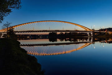Naklejka premium Troja bridge Prague over the Vltava river in the night with illumination. Trojsky most . Czech Republic