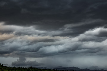 Obraz na płótnie Canvas Cloudy sky, dark clouds, close storm over mountain range