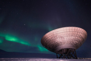 The polar Northern aurora borealis lights in Norway Svalbard in the mountains