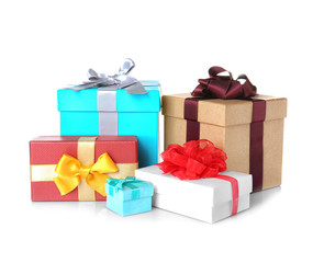 Set of beautiful gift boxes with wonderful bows of shiny ribbons on white background