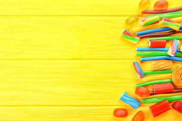 Tasty jelly candies on wooden background