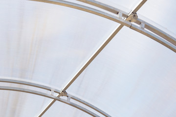 Greenhouse made of polycarbonate and metal carcass. Small hothouse for private use. Metal construction covered with transparent polycarbonate.