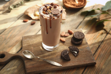 Composition with tasty cocoa drink on wooden table