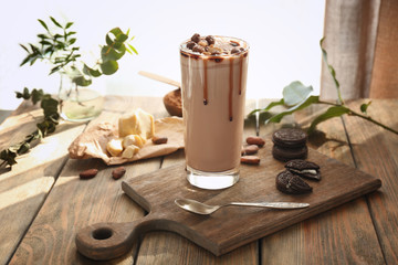 Composition with tasty cocoa drink on wooden table