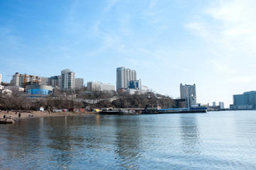 Fototapeta na wymiar Russia, Vladivostok, April 7: sea bay, city buildings