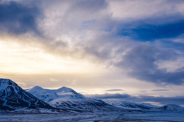 Winter mountain nature Svalbard Longyearbyen Svalbard Norway with blue sky and snowy peaks and blue sky on a sunny day with clouds wallpaper during sunset orange fire