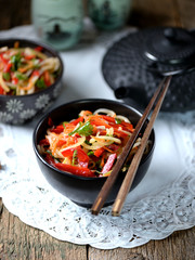 Rice noodles with onions, carrots, cucumber, peppers and coriander. Eastern cuisine.