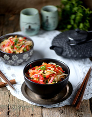Rice noodles with onions, carrots, cucumber, peppers and coriander. Eastern cuisine.