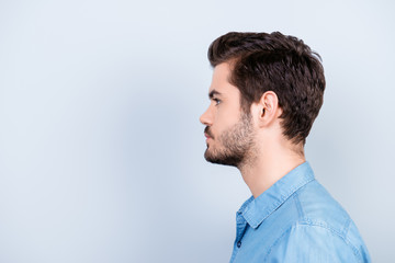 Fototapeta premium Side view portrait of serious fashionable handsome man in stylish jeans shirt