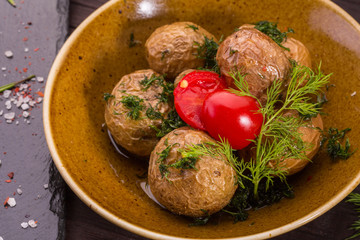 Pass sweet potato with greens and cherry tomatoes, fried on coals