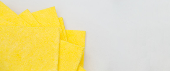 Vibrant yellow cloth kitchen napkins isolated on white.