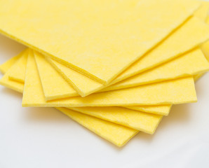 Vibrant yellow cloth kitchen napkins isolated on white.