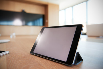 Digital Tablet On Empty Boardroom Table In Office