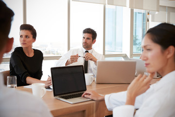 Group Of Medical Staff Meeting Around Table In Hospital