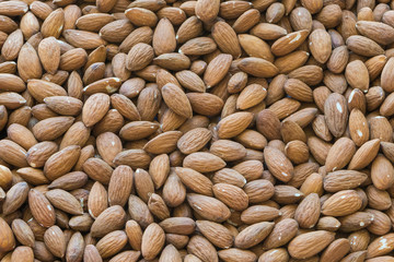 Heap of raw almonds close-up. Texture of almonds.