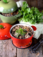 Buckwheat with chicken and mushrooms in a pot.