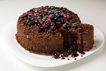 Chocolate cake with rich icing ready to eat with berries