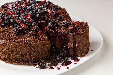 Chocolate cake with rich icing ready to eat with berries