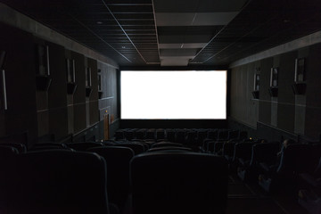 Empty cinema seats with blank white screen