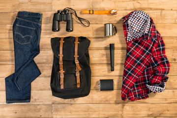 Traveler set on wooden background, flat lay