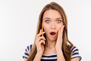 Fototapeta premium Close up portrait of shocked woman talking to somebody on the phone