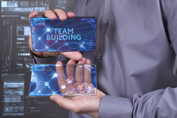 Business, Technology, Internet and network concept. Young businessman working on a virtual screen of the future and sees the inscription: Team building