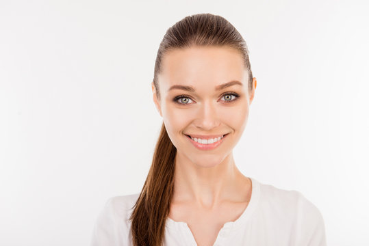 Close up portrait of pretty young smiling woman with ponytail isolated on white background