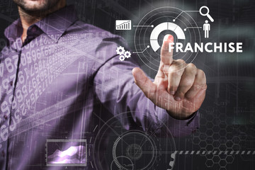 Business, Technology, Internet and network concept. Young businessman working on a virtual screen of the future and sees the inscription: Franchise